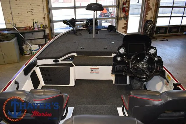 Slide: The Image of 2019 Nitro Z18 boat interior with steering console and seating in a garage setting. - 32