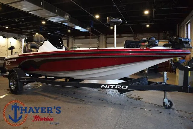 Slide: The Image of 2019 Nitro Z18 boat in showroom, red and white design, displayed on trailer. - 39