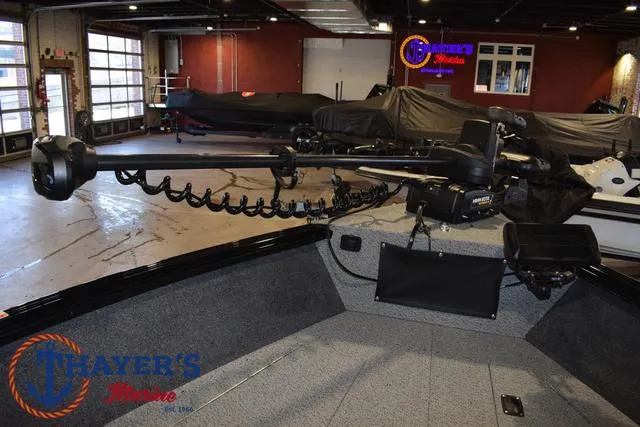 Slide: The Image of 2024 Lund 1775 Impact XS Sport boat interior with advanced trolling motor in showroom. - 11