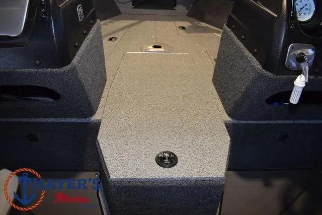 Slide: The Image of 2024 Lund 1775 Impact XS Sport boat interior with carpeted flooring. - 14