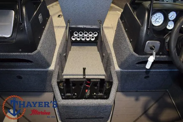 Slide: The Image of 2024 Lund 1775 Impact XS Sport boat interior with rod storage and dashboard. - 15