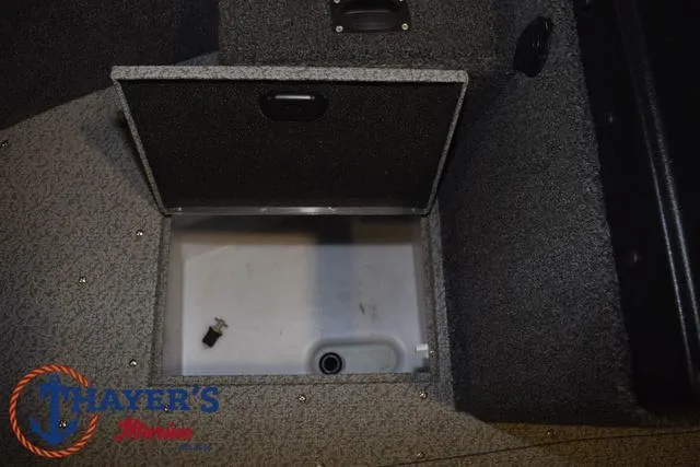 Slide: The Image of 2024 Lund 1775 Impact XS Sport boat storage compartment, open lid, gray interior. - 20