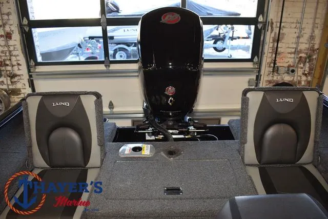Slide: The Image of 2024 Lund 1775 Impact XS Sport boat interior with motor and seating. - 28