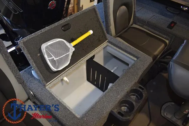 Slide: The Image of 2024 Lund 1775 Impact XS Sport boat interior with storage compartment and fishing net. - 29