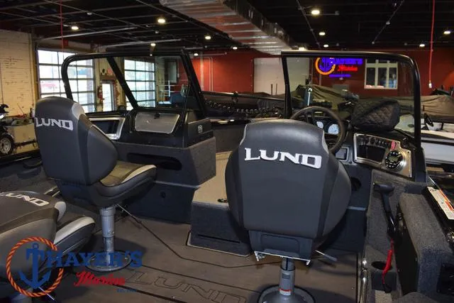 Slide: The Image of 2024 Lund 1775 Impact XS Sport boat interior with branded seats and dashboard. - 33