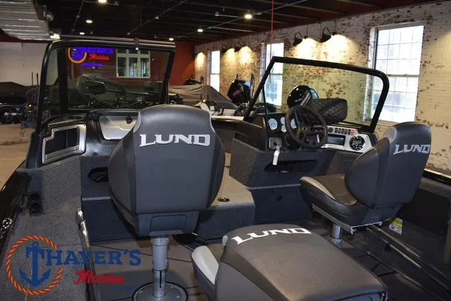 Slide: The Image of 2024 Lund 1775 Impact XS Sport boat interior with branded seats at Thayer's Marine showroom. - 34