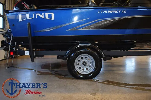 Slide: The Image of 2024 Lund 1775 Impact XS Sport boat, blue exterior, displayed at Thayer's Marine. - 4