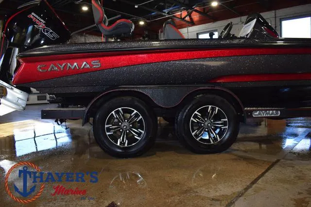 Slide: The Image of 2022 Caymas CX 21 boat on trailer, displayed indoors at Thayer's Marine. - 11