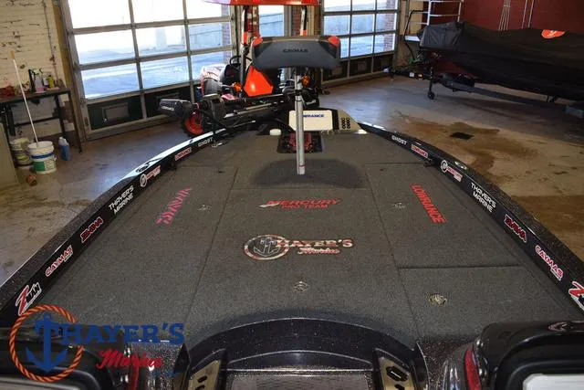 Slide: The Image of 2022 Caymas CX 21 boat interior with fishing deck and equipment in a garage setting. - 15