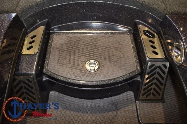 Slide: The Image of 2022 Caymas CX 21 boat deck with storage compartment and Thayer's Marine logo. - 21