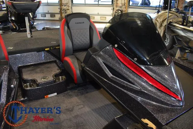 Slide: The Image of 2022 Caymas CX 21 boat interior with seating and dashboard, displayed at Thayer's Marine. - 24