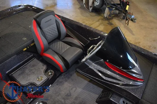 Slide: The Image of 2022 Caymas CX 21 boat interior with black and red seating and sleek dashboard design. - 25