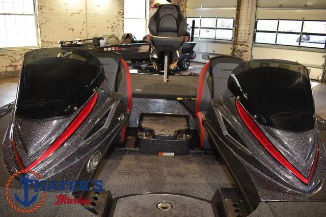 Slide: The Image of 2022 Caymas CX 21 boat interior with dual consoles in a showroom setting. - 26