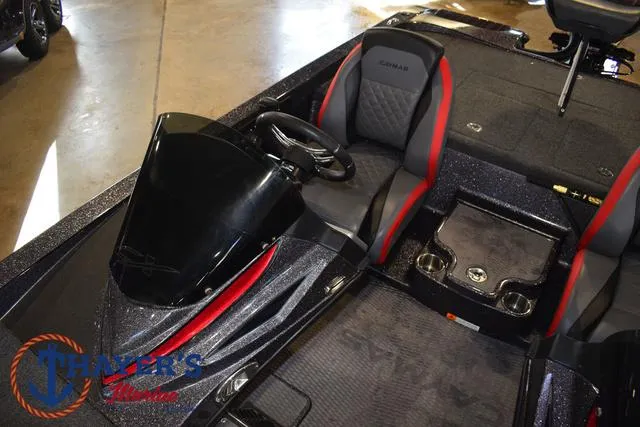 Slide: The Image of 2022 Caymas CX 21 boat interior with black and red seating, steering wheel, and console. - 27