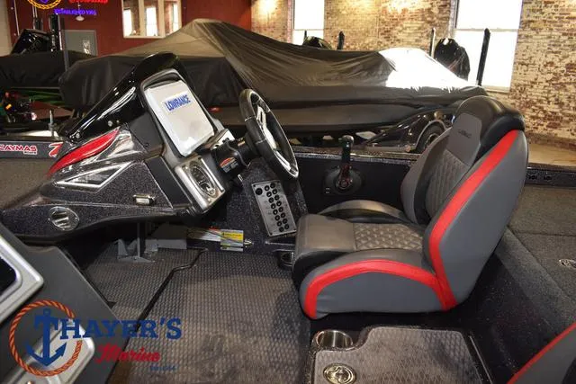 Slide: The Image of 2022 Caymas CX 21 boat interior with steering wheel and seating. - 28