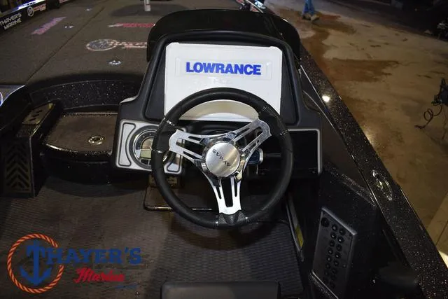 Slide: The Image of 2022 Caymas CX 21 boat dashboard with Lowrance display and steering wheel. - 29