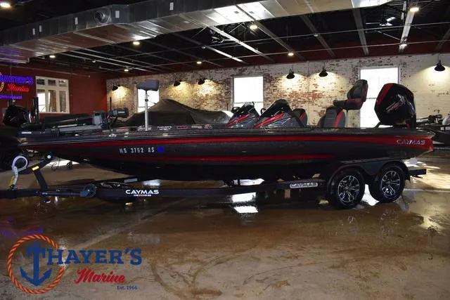 Slide: The Image of 2022 Caymas CX 21 boat displayed indoors at Thayer's Marine showroom. - 3