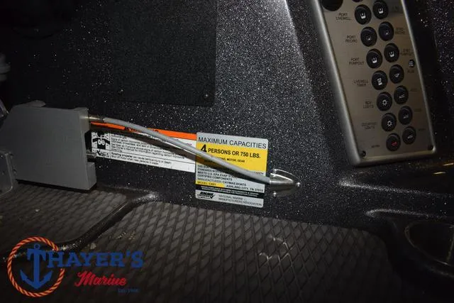 Slide: The Image of 2022 Caymas CX 21 boat interior with capacity label and control panel. - 33