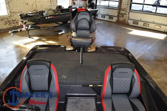 Slide: The Image of 2022 Caymas CX 21 boat interior with seating, displayed in a showroom. - 36