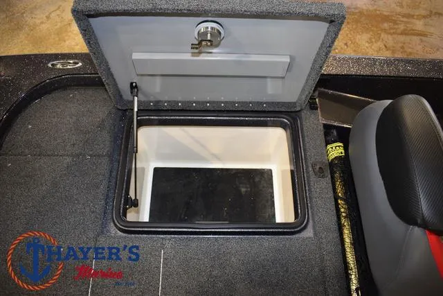 Slide: The Image of 2022 Caymas CX 21 boat storage compartment with open lid, featuring a hydraulic lift. - 38