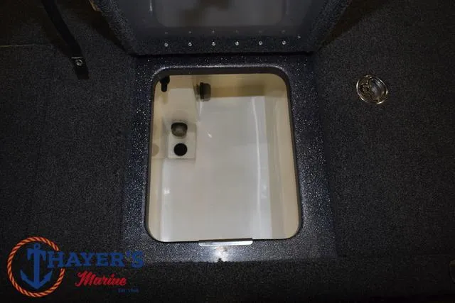 Slide: The Image of 2022 Caymas CX 21 boat storage compartment with Thayer's Marine logo. - 39