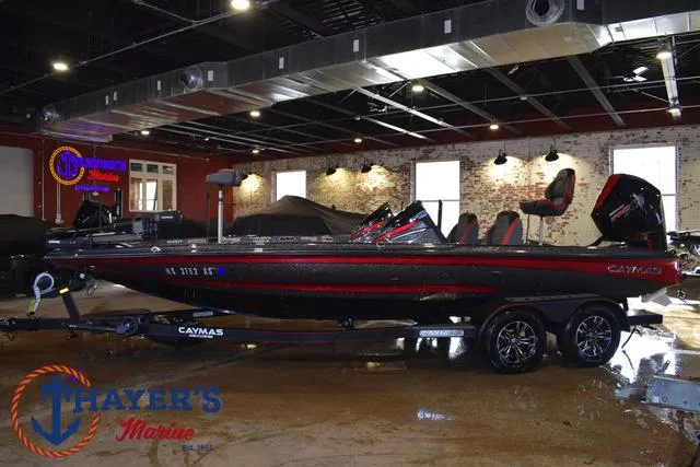 Slide: The Image of 2022 Caymas CX 21 boat displayed indoors at Thayer's Marine showroom. - 4