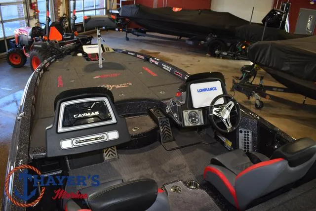 Slide: The Image of 2022 Caymas CX 21 boat interior with steering wheel and electronic displays in showroom. - 43