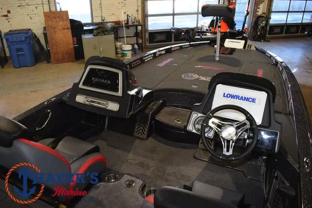 Slide: The Image of 2022 Caymas CX 21 boat interior with steering wheel and electronic displays in a showroom. - 45