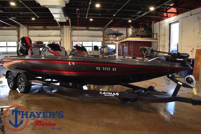 Slide: The Image of 2022 Caymas CX 21 boat displayed indoors at Thayer's Marine showroom. - 49