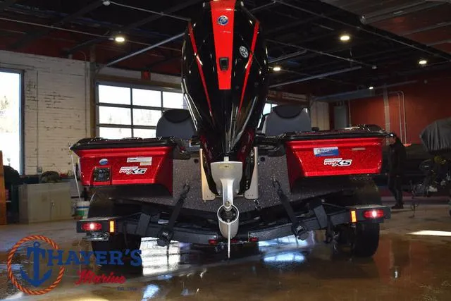 Slide: The Image of 2022 Caymas CX 21 boat in showroom, rear view with powerful engine. - 6