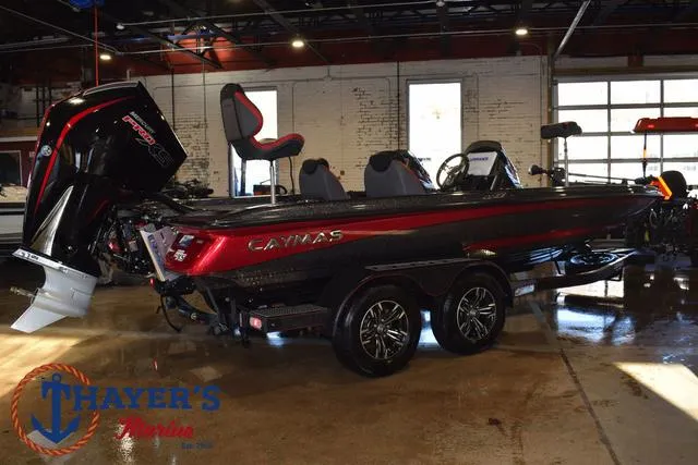 Slide: The Image of 2022 Caymas CX 21 boat in showroom, featuring sleek design and powerful engine. - 7
