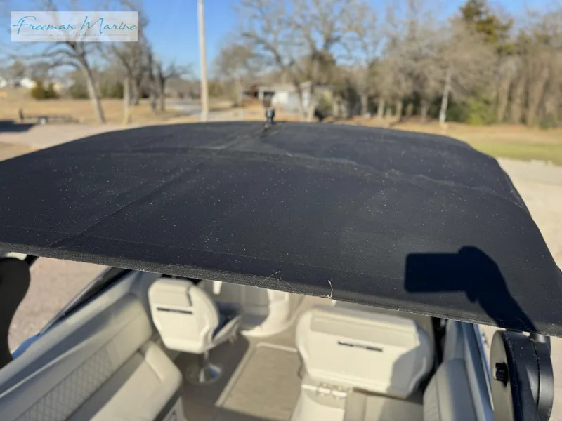 Slide: The Image of 2020 Sea Ray SLX 280 boat interior with black canopy, outdoor setting. - 25