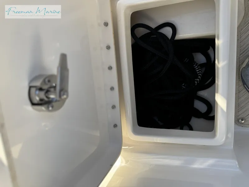Slide: The Image of Open storage compartment on 2020 Sea Ray SLX 280 boat. - 26