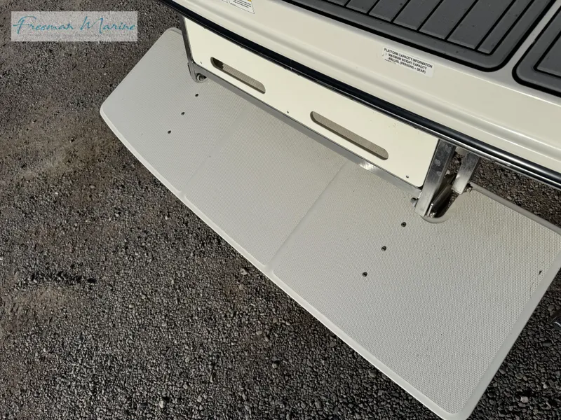 Slide: The Image of 2020 Sea Ray SLX 280 swim platform on gravel surface. - 29