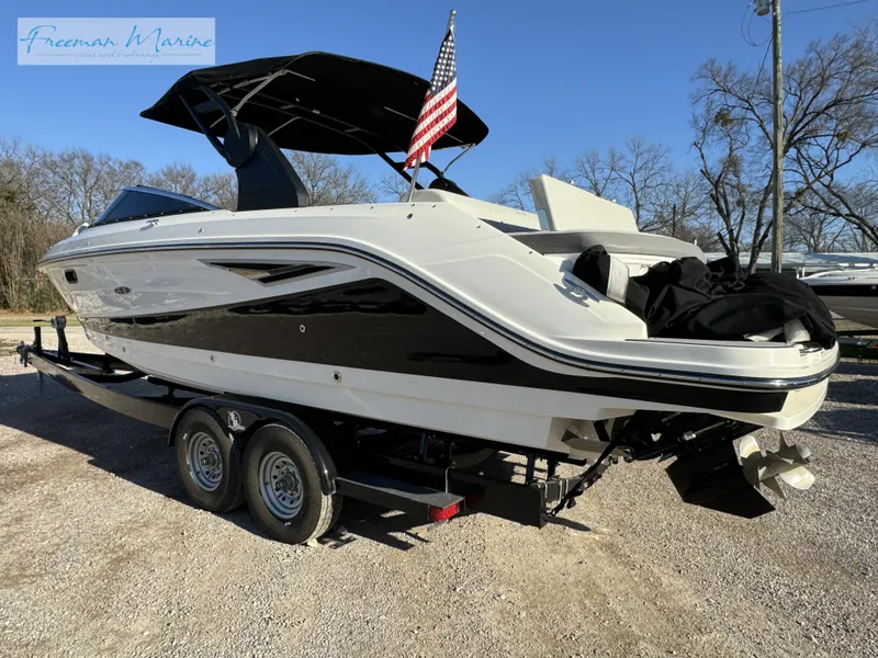 Slide: The Image of 2020 Sea Ray SLX 280 boat on trailer with American flag, parked outdoors. - 3
