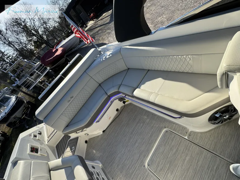 Slide: The Image of 2020 Sea Ray SLX 280 boat interior with beige seating and American flag. - 49