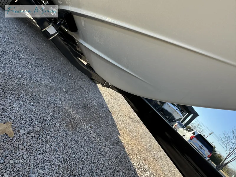 Slide: The Image of 2020 Sea Ray SLX 280 boat on trailer, parked on gravel. - 9