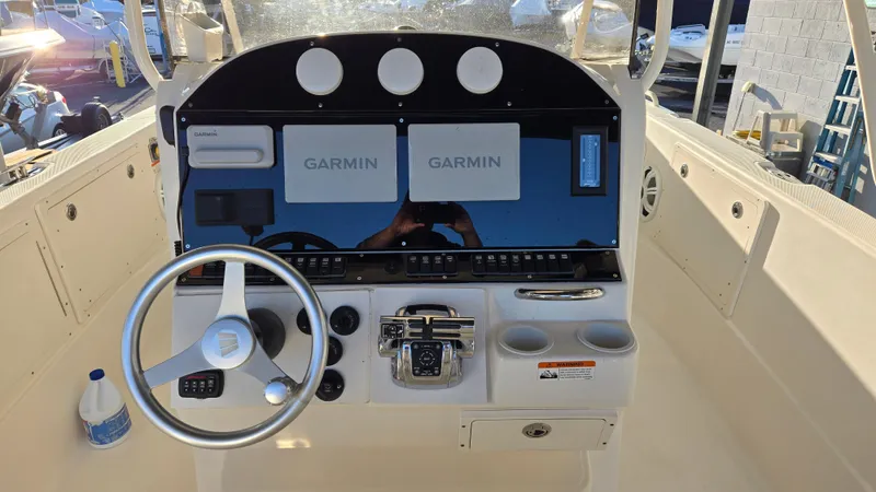 Slide: The Image of 2006 Wellcraft 352 Sport boat dashboard with Garmin navigation systems and steering wheel. - 13