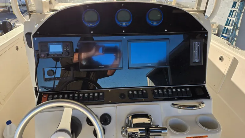 Slide: The Image of 2006 Wellcraft 352 Sport boat dashboard with steering wheel and electronic displays. - 14