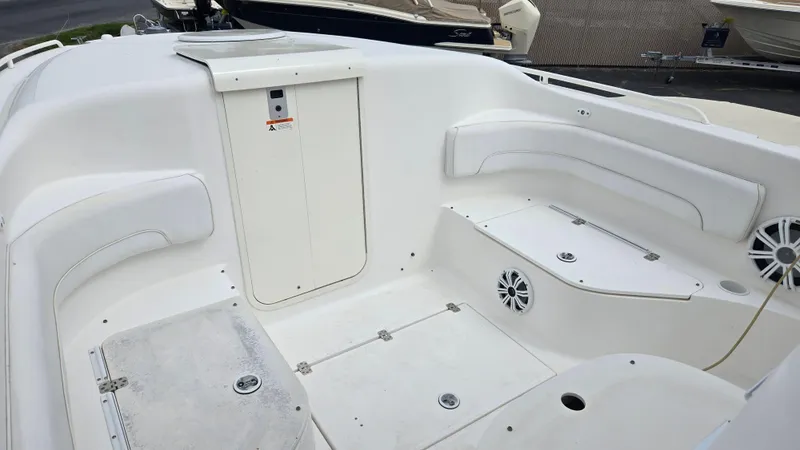 Slide: The Image of 2006 Wellcraft 352 Sport Scarab boat interior with white seating and storage compartments. - 17