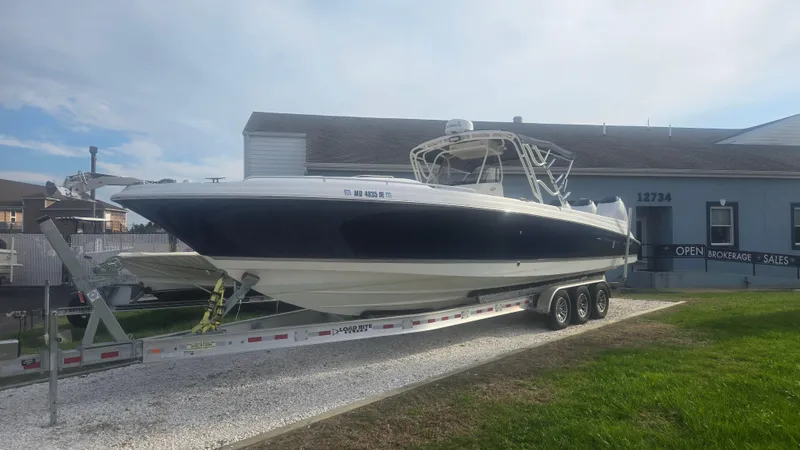 Slide: The Image of 2006 Wellcraft 352 Sport Scarab boat on trailer outside a building. - 22