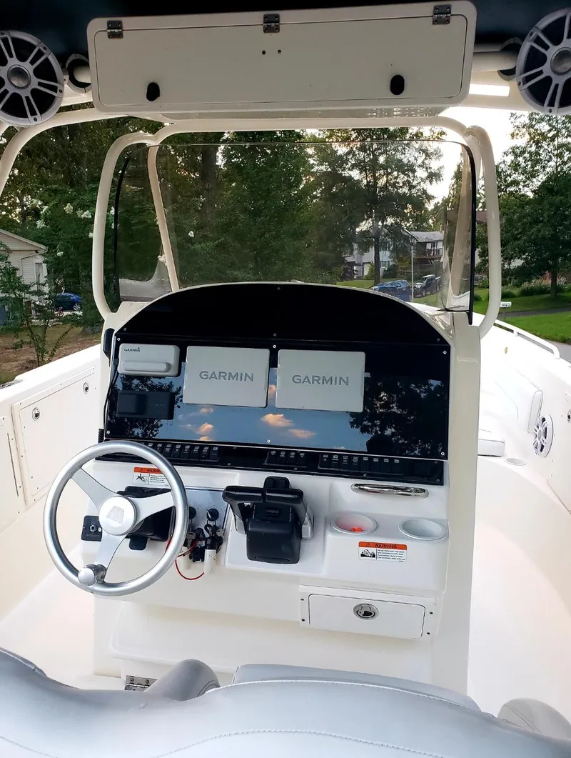 Slide: The Image of 2006 Wellcraft 352 Sport boat cockpit with Garmin navigation displays and steering wheel. - 4