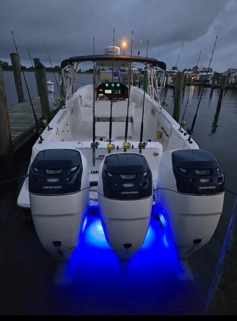 Slide: The Image of 2006 Wellcraft 352 Sport boat with triple engines and blue underwater lights at dock. - 5