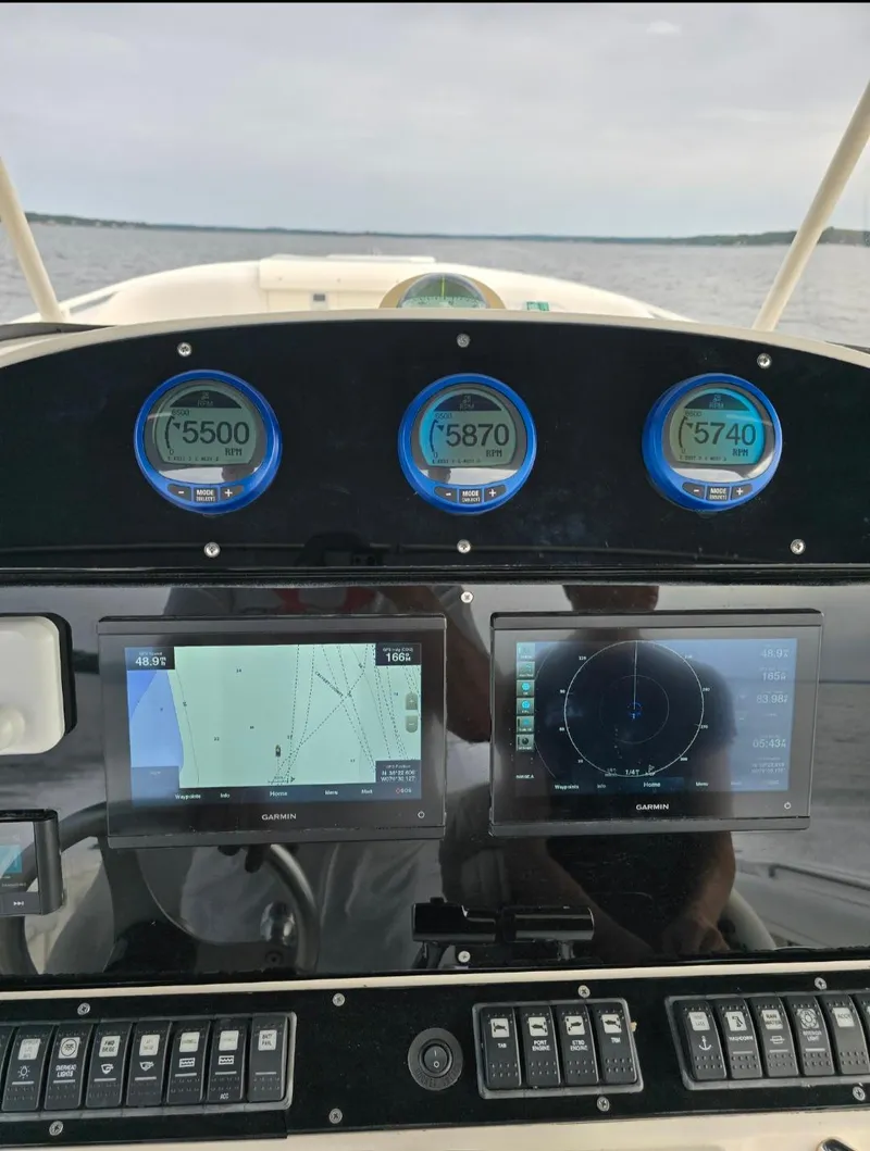 Slide: The Image of Dashboard of a 2006 Wellcraft 352 Sport boat with navigation and engine displays. - 8