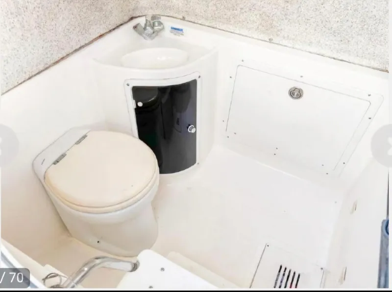 Slide: The Image of 2006 Wellcraft 352 Sport boat bathroom with toilet and sink. - 9