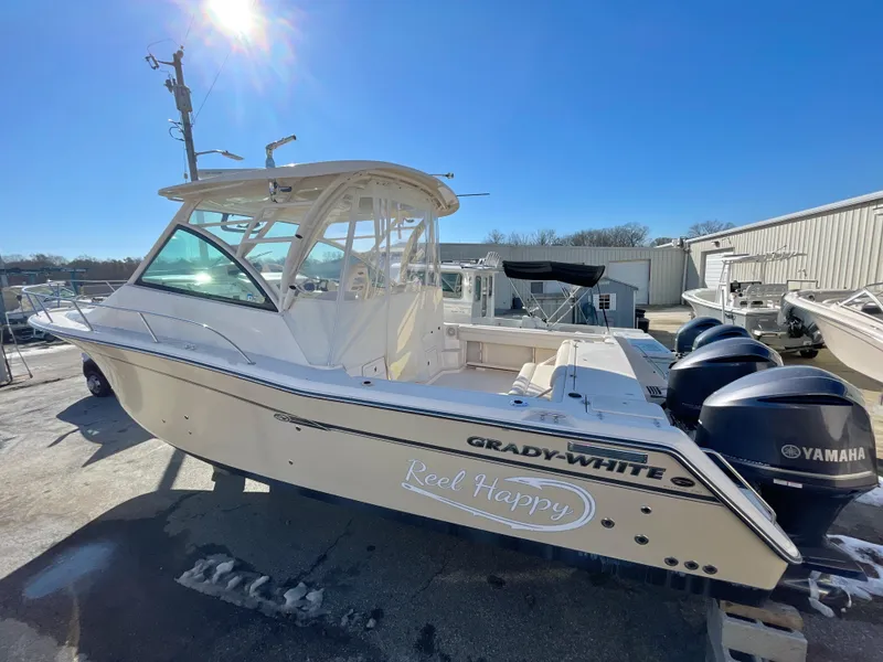 Slide: The Image of 2015 Grady-White Express 330 boat with Yamaha engines, docked under clear blue sky. - 0