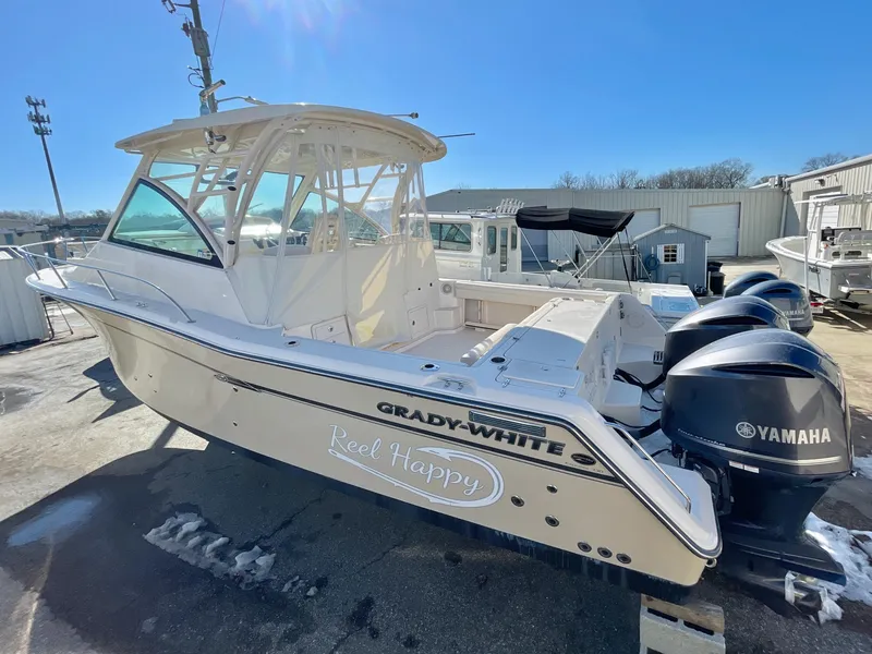 Slide: The Image of 2015 Grady-White Express 330 boat with Yamaha engines, docked outdoors on a sunny day. - 1