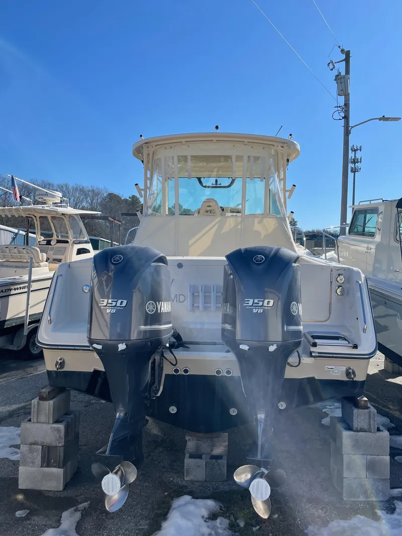 Slide: The Image of 2015 Grady-White Express 330 boat with twin Yamaha 350 engines, docked outdoors. - 10