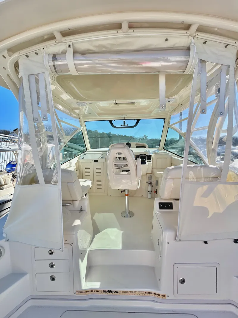 Slide: The Image of 2015 Grady-White Express 330 boat interior with helm and seating area. - 19