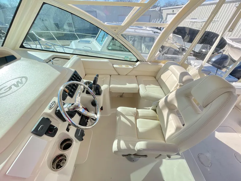 Slide: The Image of 2015 Grady-White Express 330 boat interior with steering wheel and seating. - 24